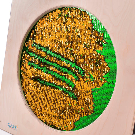 Sequin Flip Sensory Wall Panel close-up with green and gold reversible sequins in a round window
